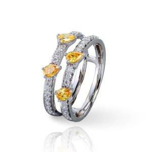 Indulge in the captivating radiance of our Sunlit Splendor Double Layer Diamond Ring. This exquisite ring features two layers of sparkling diamonds, with a vibrant yellow stone at its center. The unique design and meticulous craftsmanship create a mesmerizing display of light and color. Let this lab grown diamond ring become a reflection of your unique style, effortlessly capturing attention and adding a touch of vibrant beauty to your everyday look.